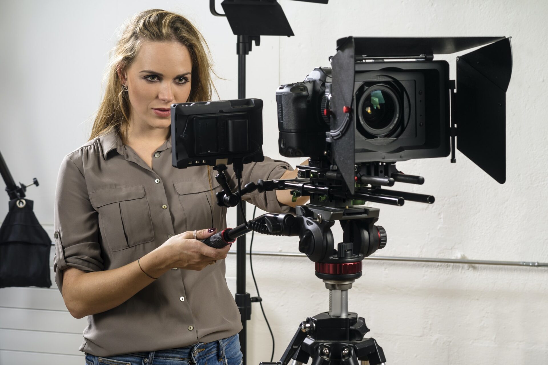 Beautiful woman operating a video camera rig